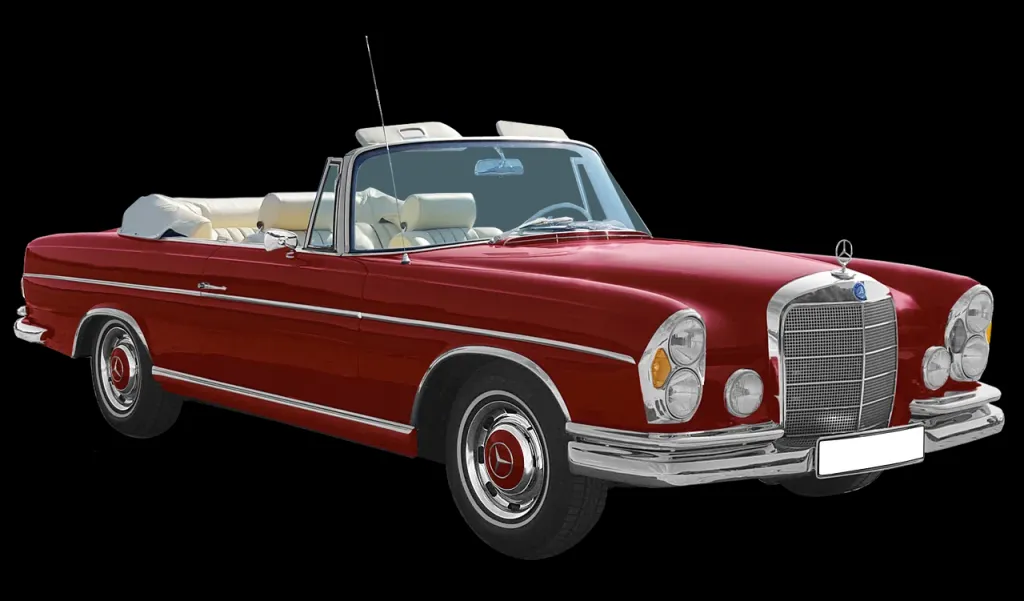 Lśniący, zabytkowy samochód sportowy zaparkowany w eleganckim otoczeniu, symbolizujący luksus i motoryzacyjną historię.